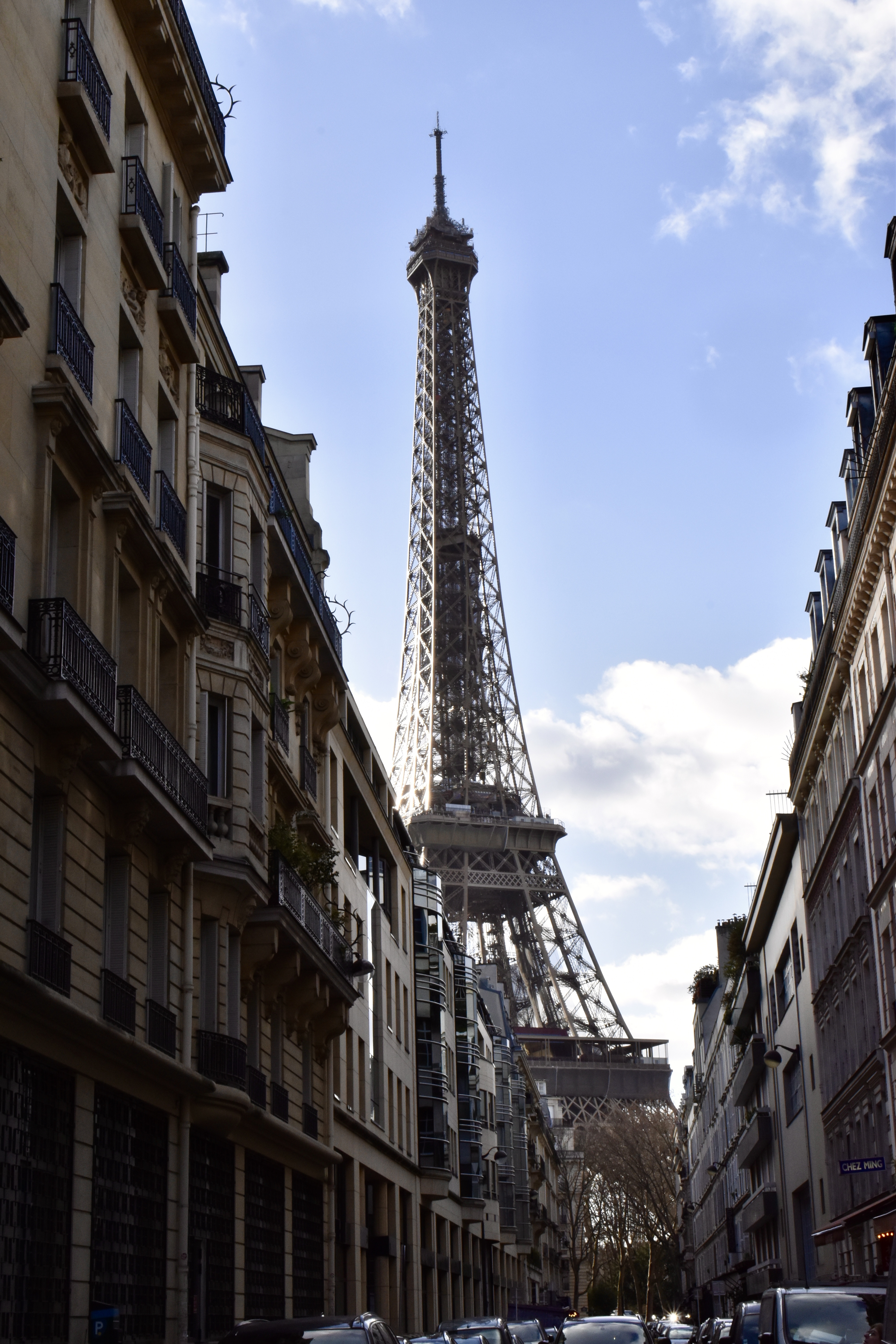 Eiffel Tower framed between Parisian buildings